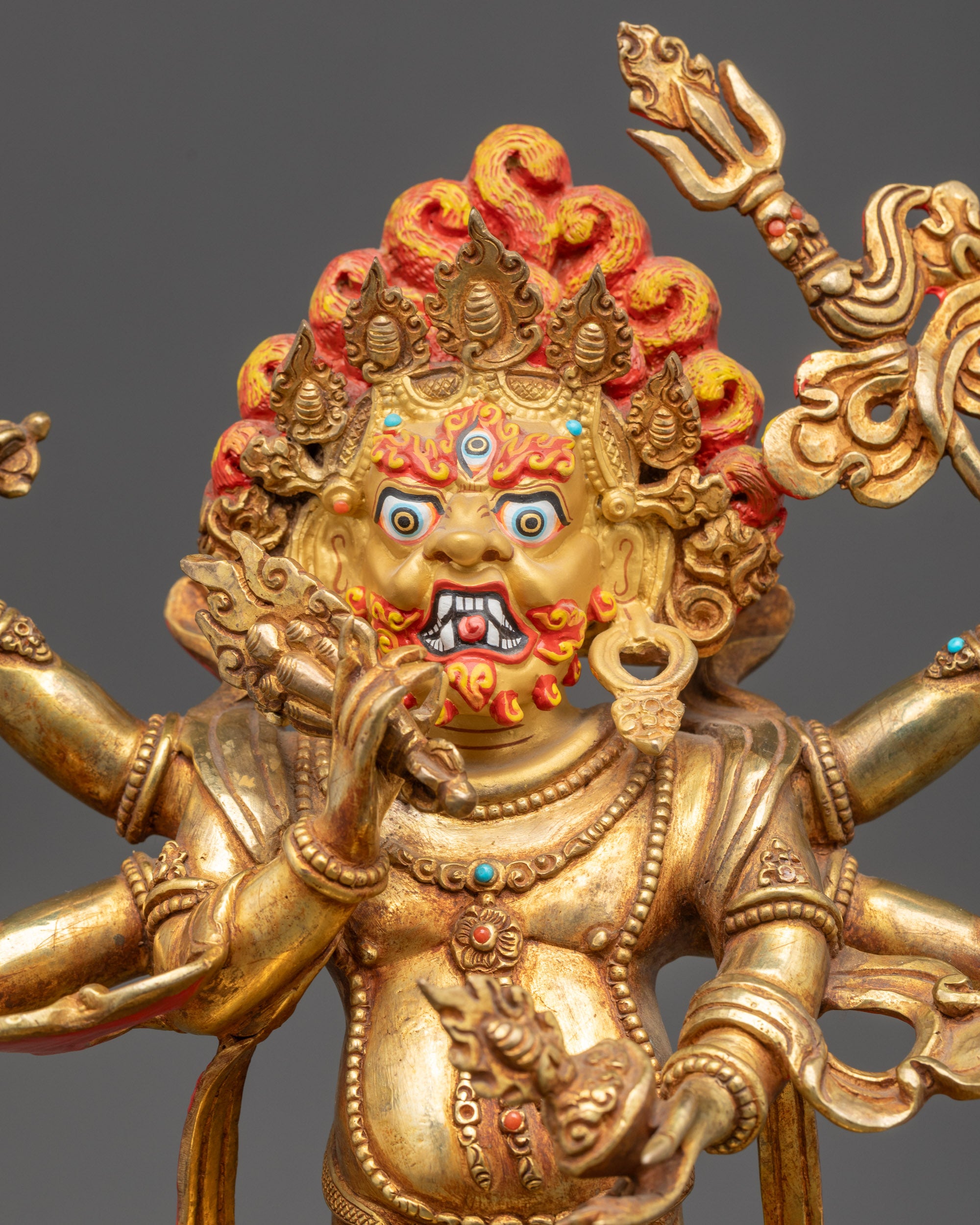 Regular close up of White Mahakala statue showing crown, flowing robes, and sacred jewelry
