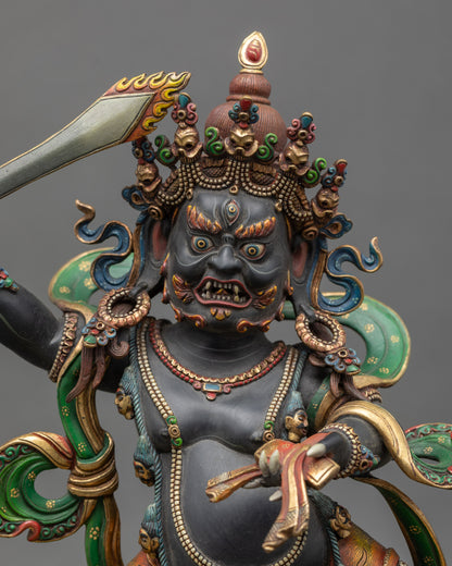 Regular close up of wrathful Manjushri statue showing gold-plated finish and vibrant colors