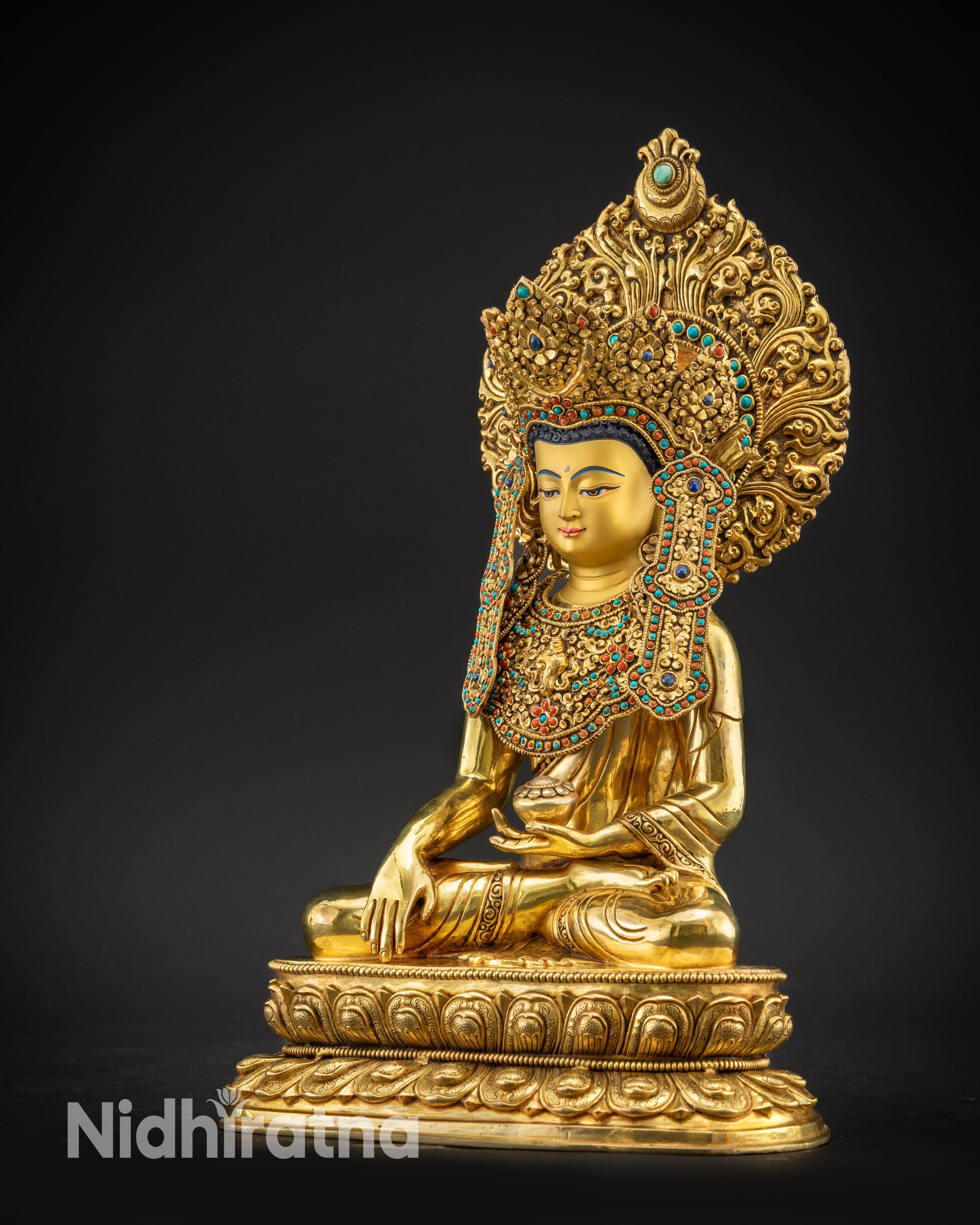 Regular left side view of sacred Jowo Rinpoche Buddha statue adorned with stones
