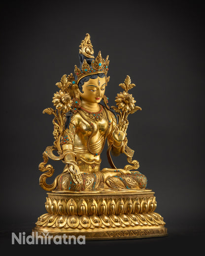 Regular right side view White Tara sculpture holding utpala flower seated lotus base
