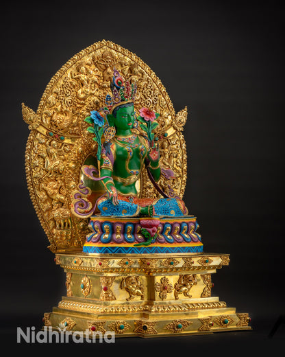 Regular side left view of Green Tara seated on intricate Tibetan Buddhist throne
