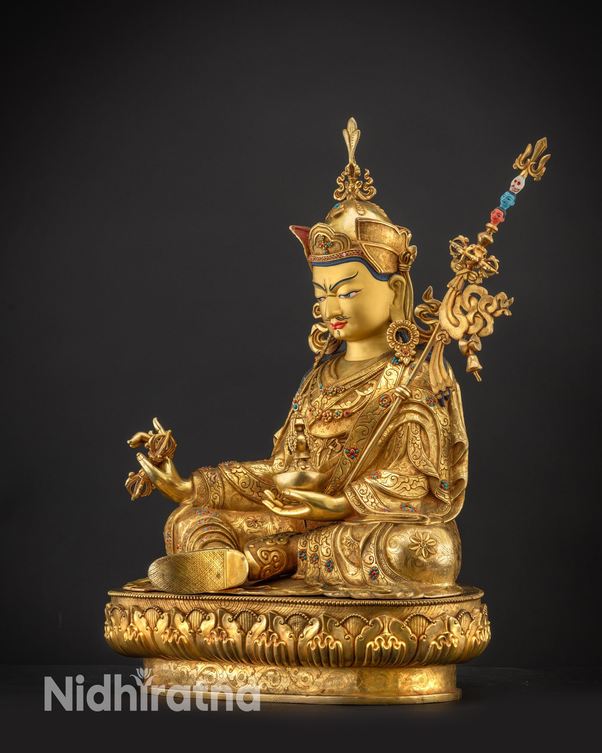 Regular side left view of Guru Padmasambhava statue showing lotus crown
