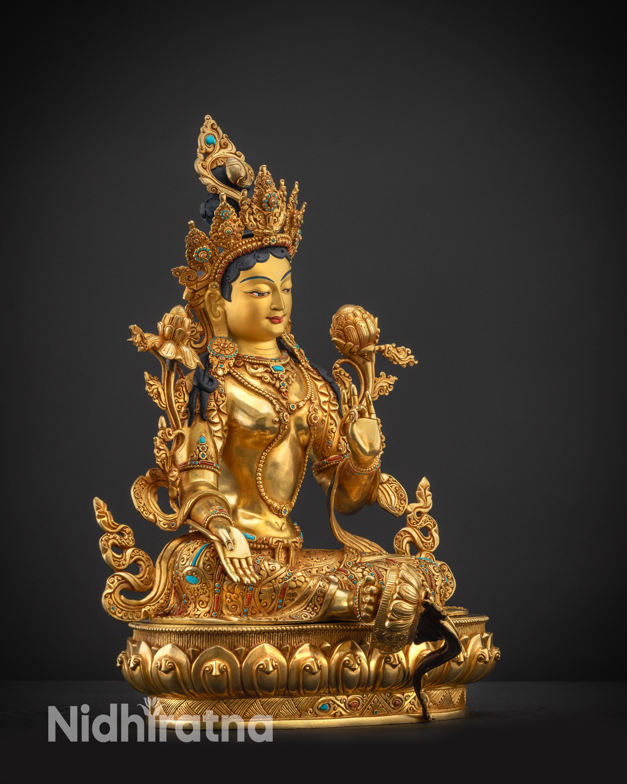 Regular side right view of Green Tara statue on lotus seat with flowing robes
