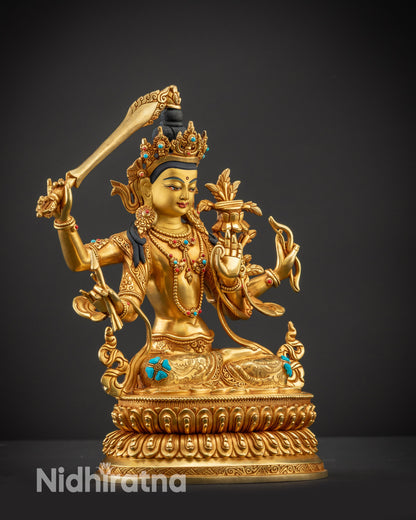 Regular side right view of Maha Manjushri statue showing four arms and fire-gilded details
