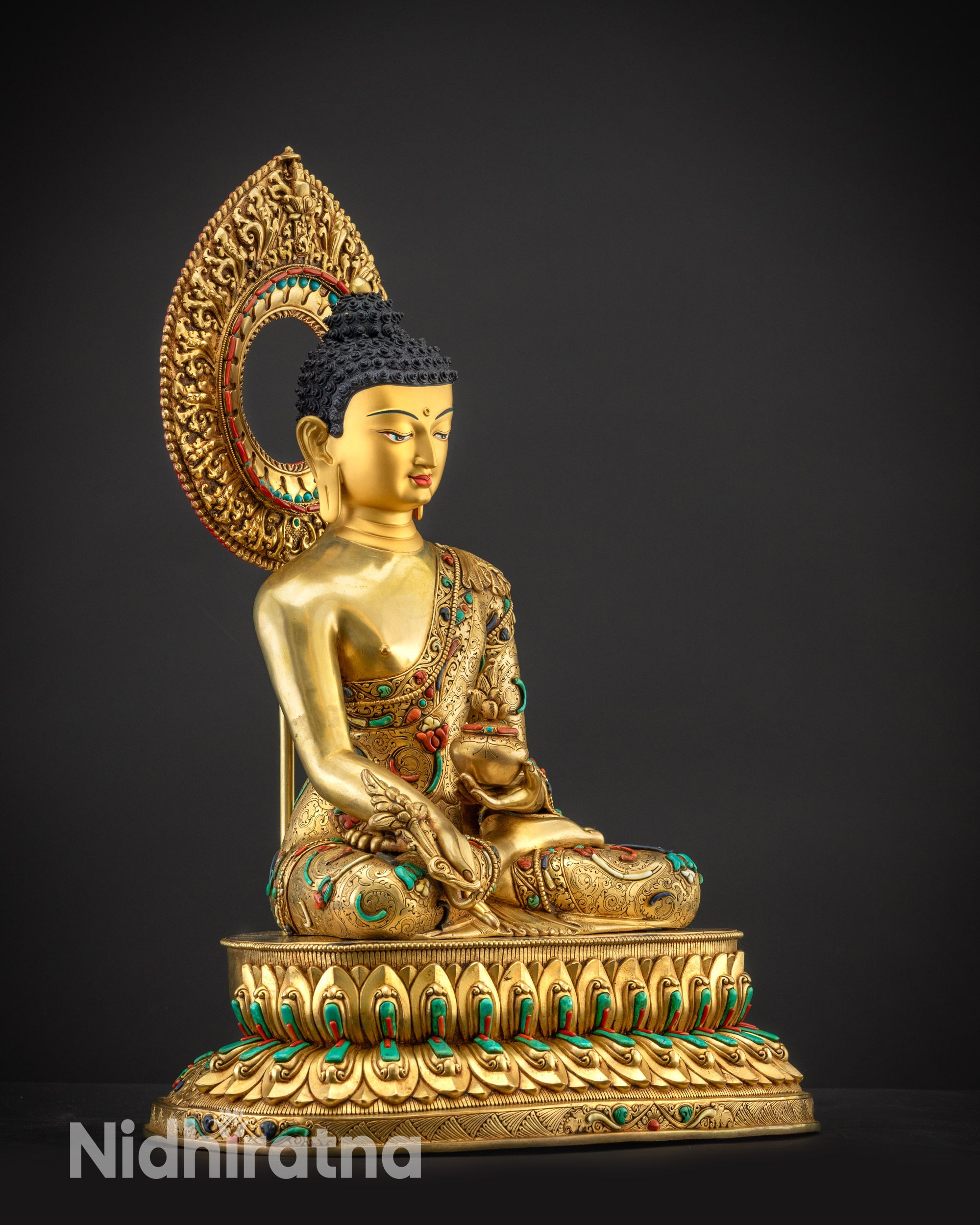 Regular side right view of Medicine Buddha with flowing carved robes and halo adornments