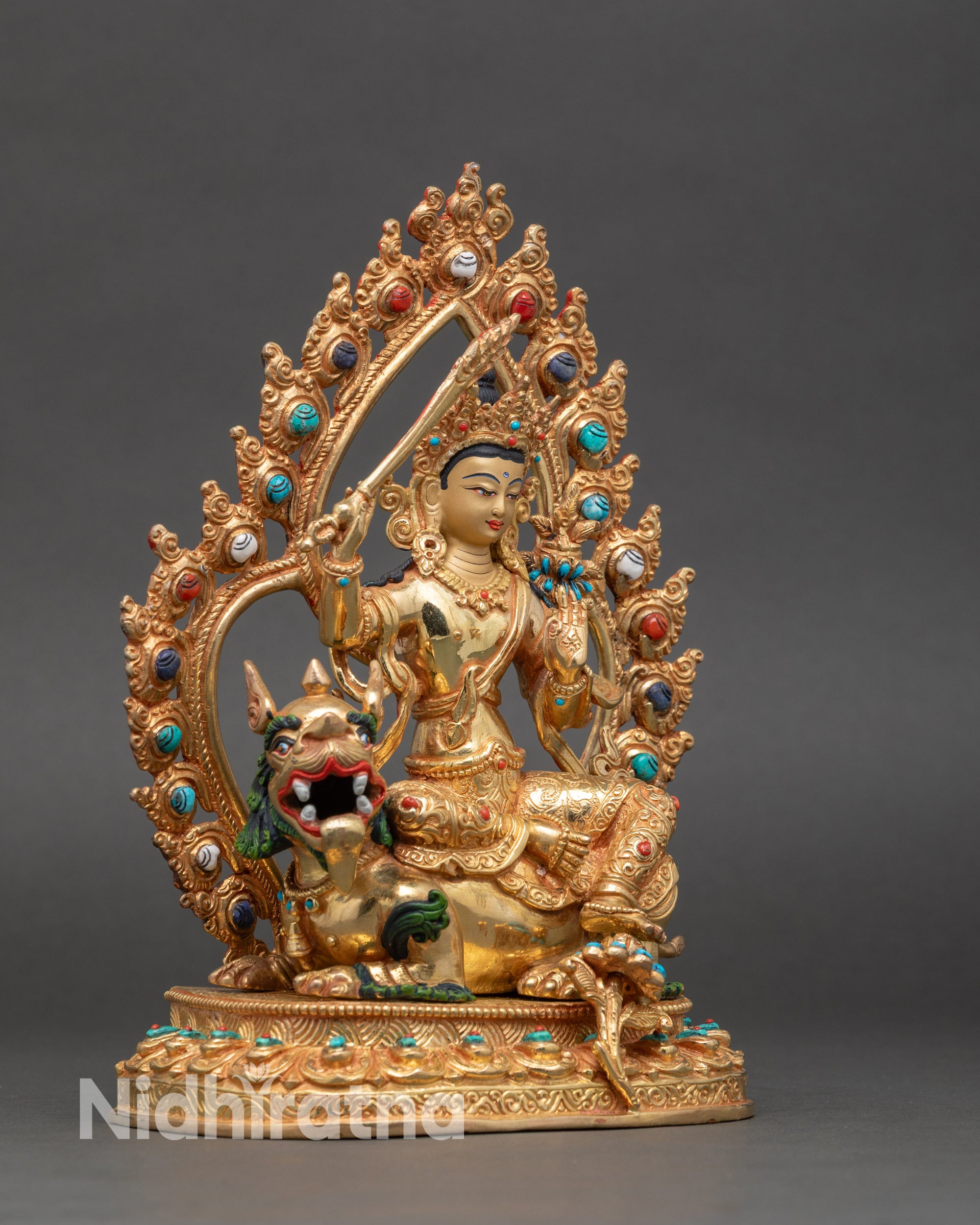 Right profile of Simhada Manjushri statue seated on lion throne holding sword and flower
