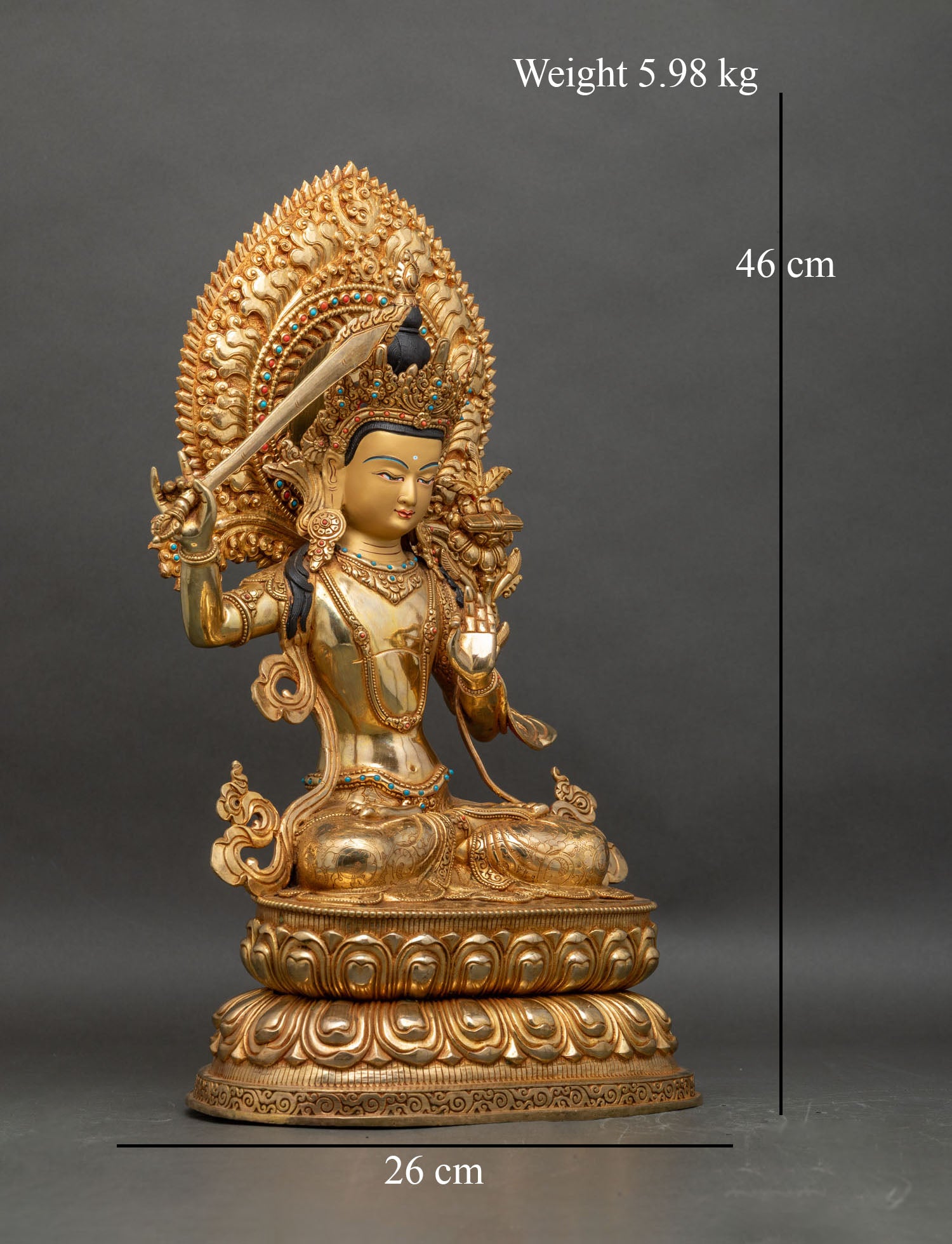 Right profile of Manjushri statue holding wisdom sword and lotus stem, gilded copper Nepal