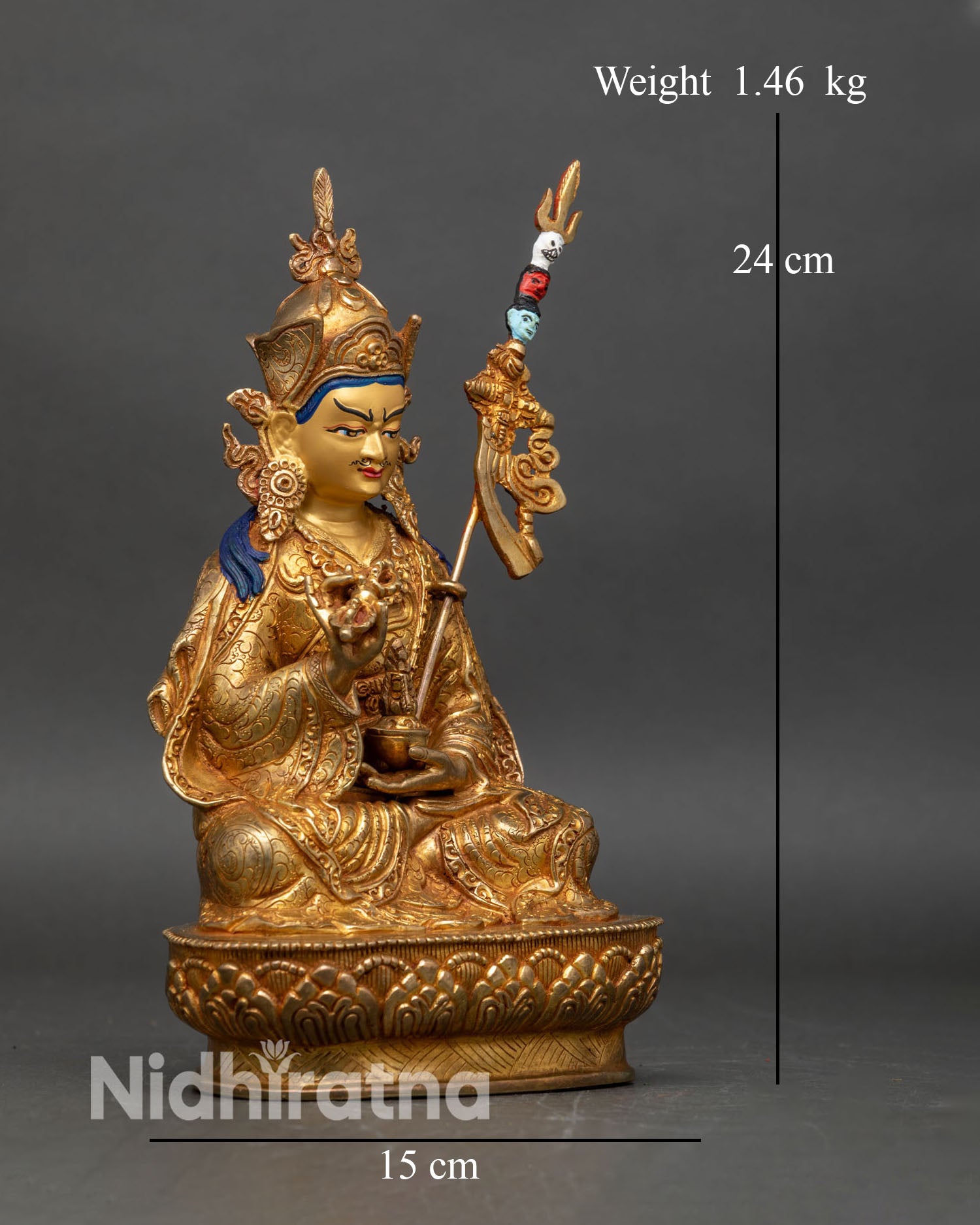 Right profile of Tsokye Dorje statue holding vajra and skull cup on lotus seat