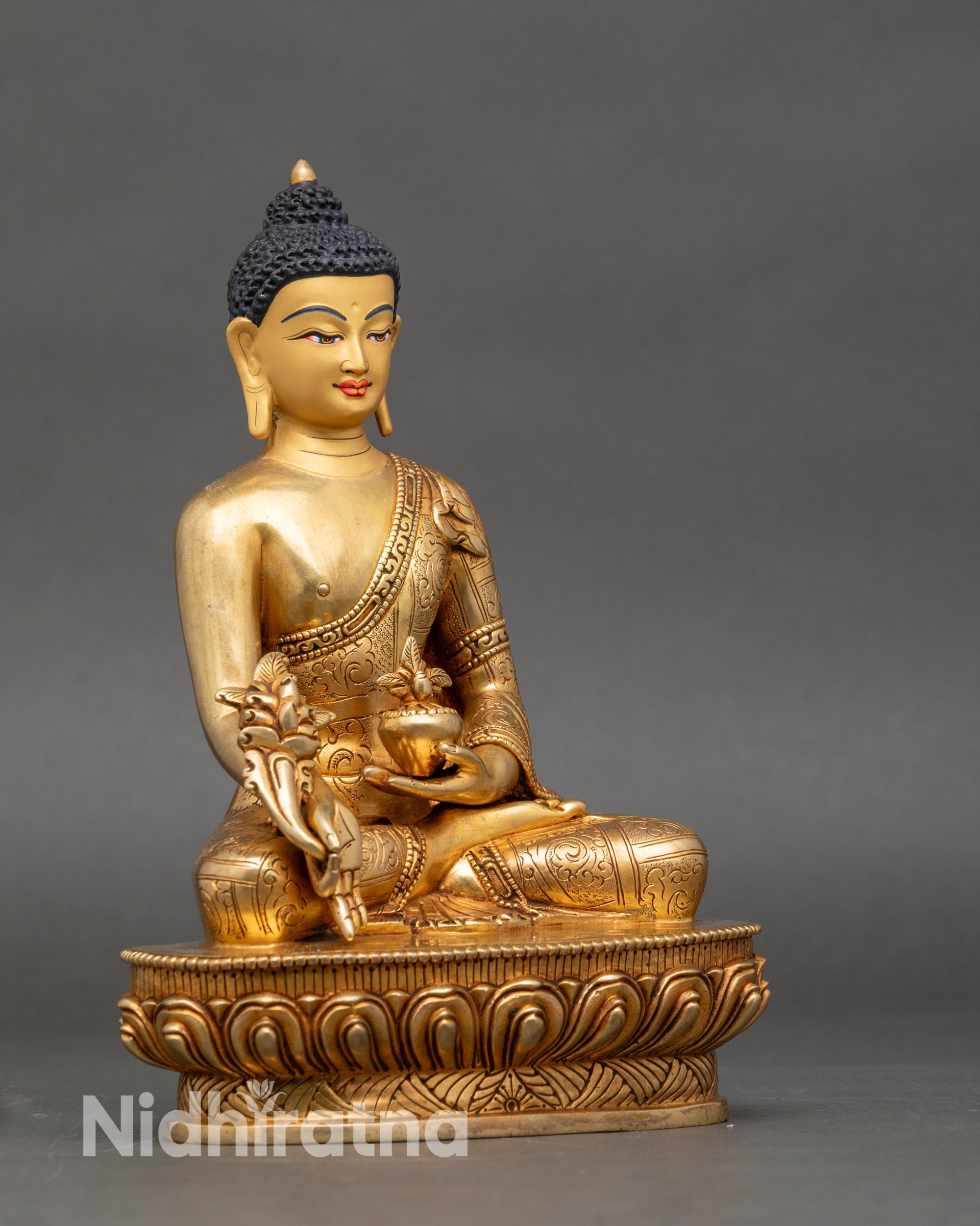 Right side view of Medicine Buddha statue on lotus pedestal, copper and gold altar art