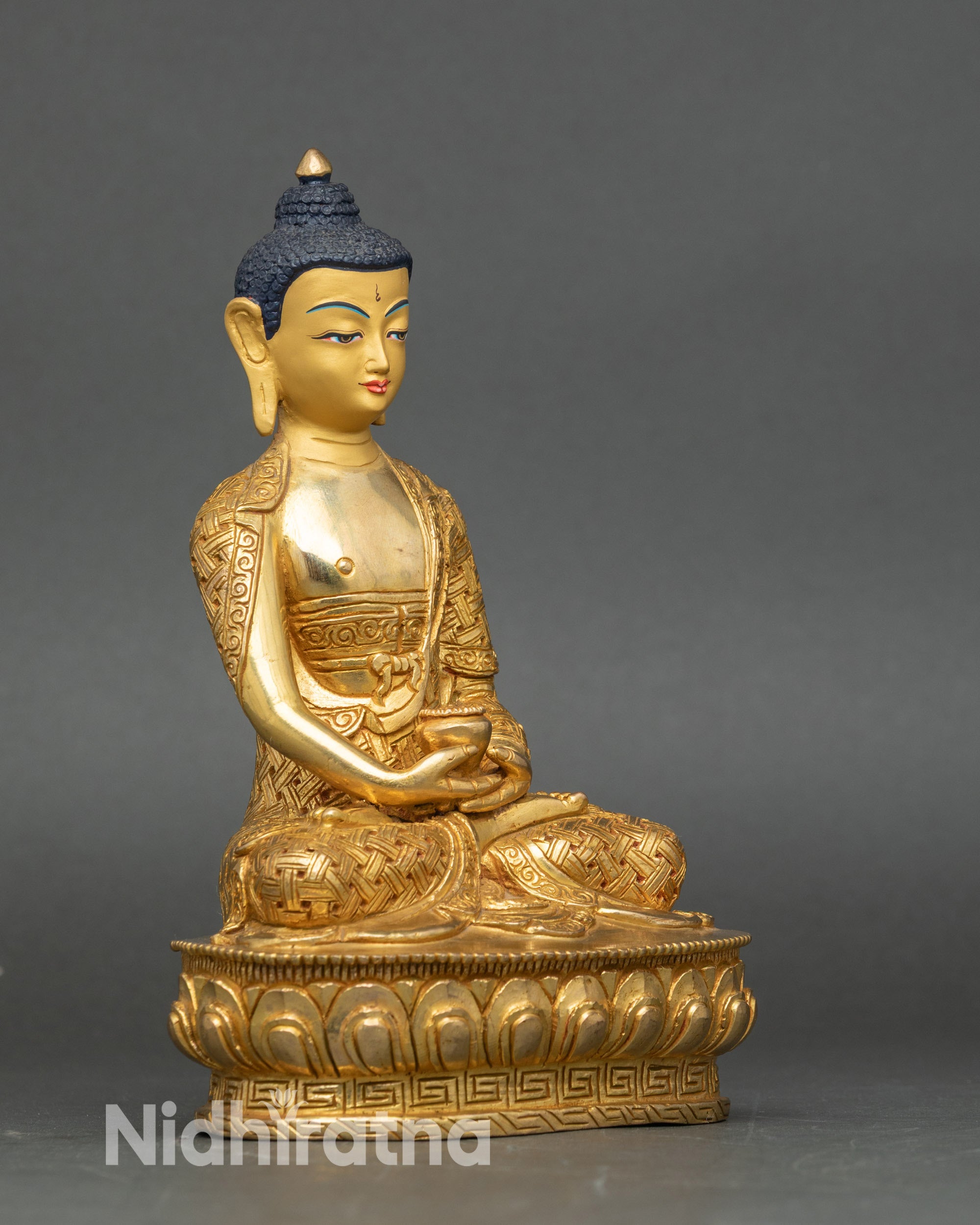 Right-side view of Amitabha Buddha statue, seated on lotus, holding monk’s bowl in dhyana mudra