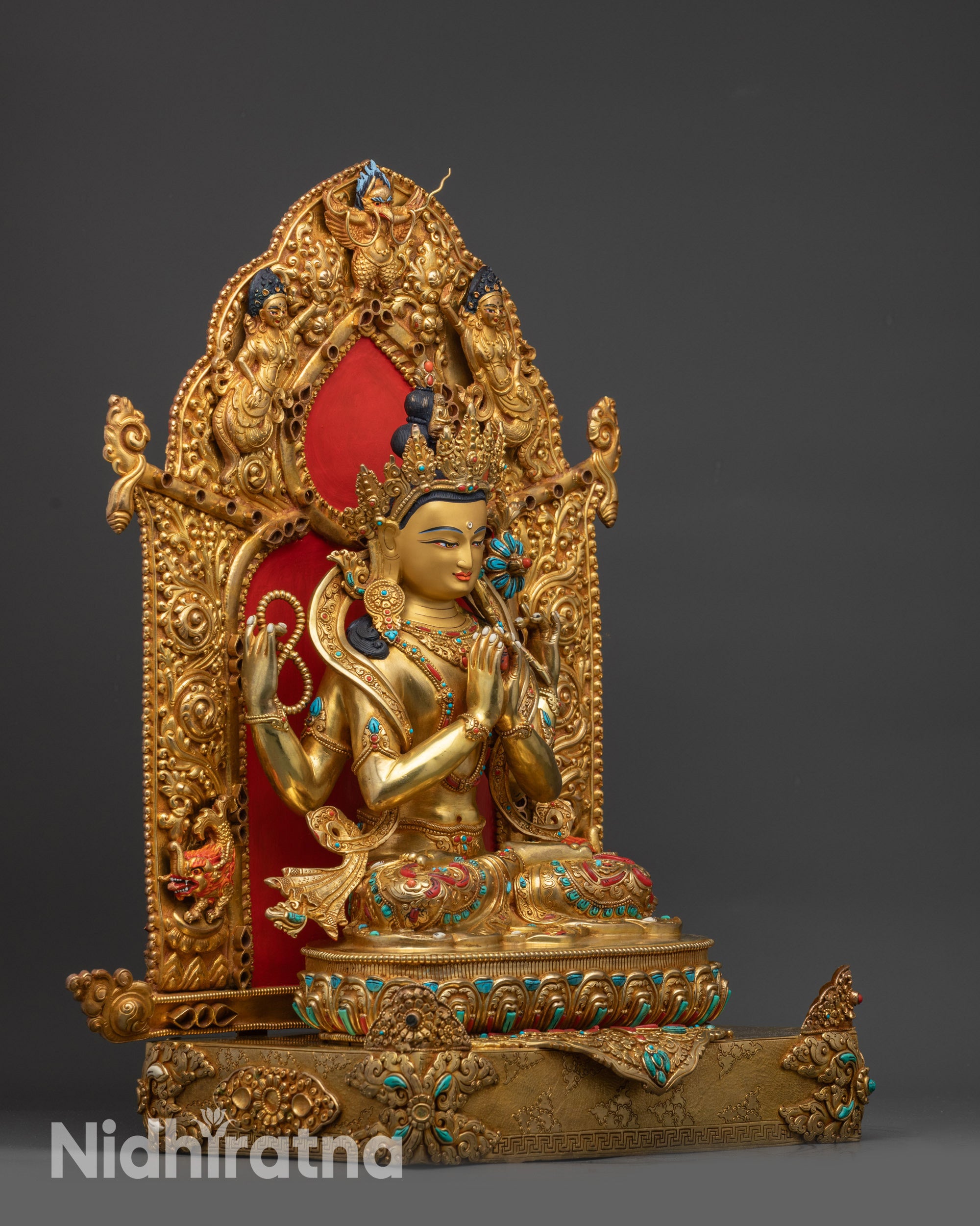 Right-side view of gold fire-gilded Chenrezig statue with four arms and carved floral garments
