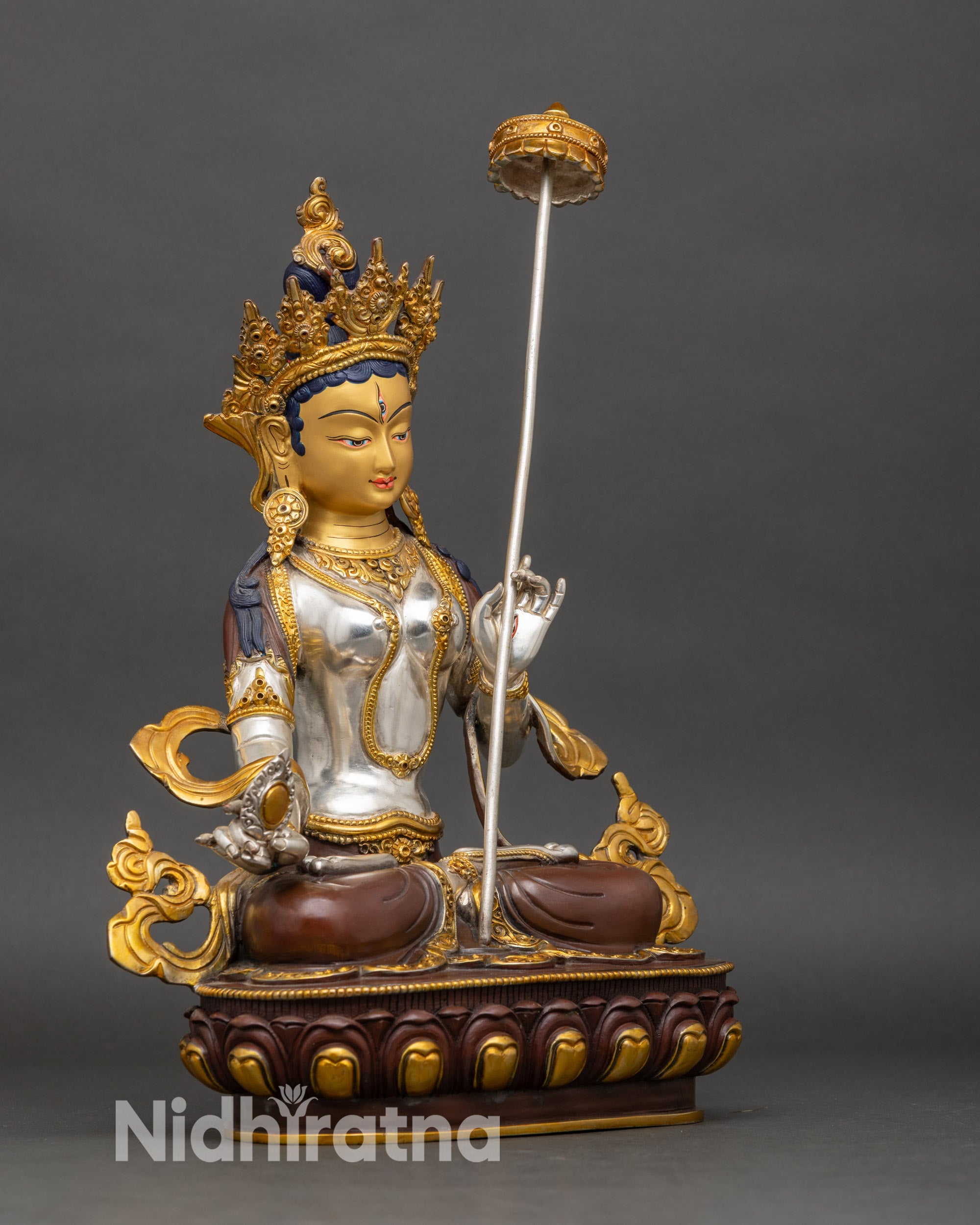 Right profile of Dukar Sitatapatra statue holding sacred parasol Tibetan Buddhist protector