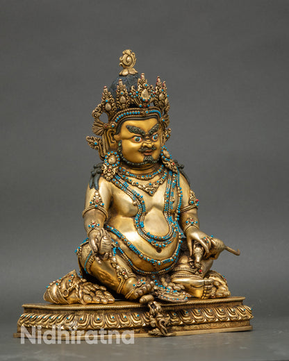 Right profile of Dzambhala statue adorned with jewels, radiating sacred prosperity