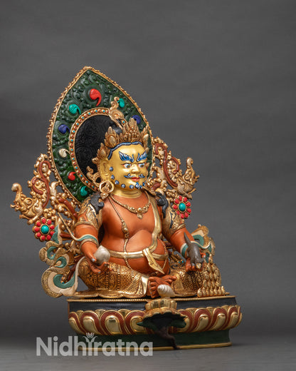 Right profile of Dzambhala statue holding mongoose and citron fruit