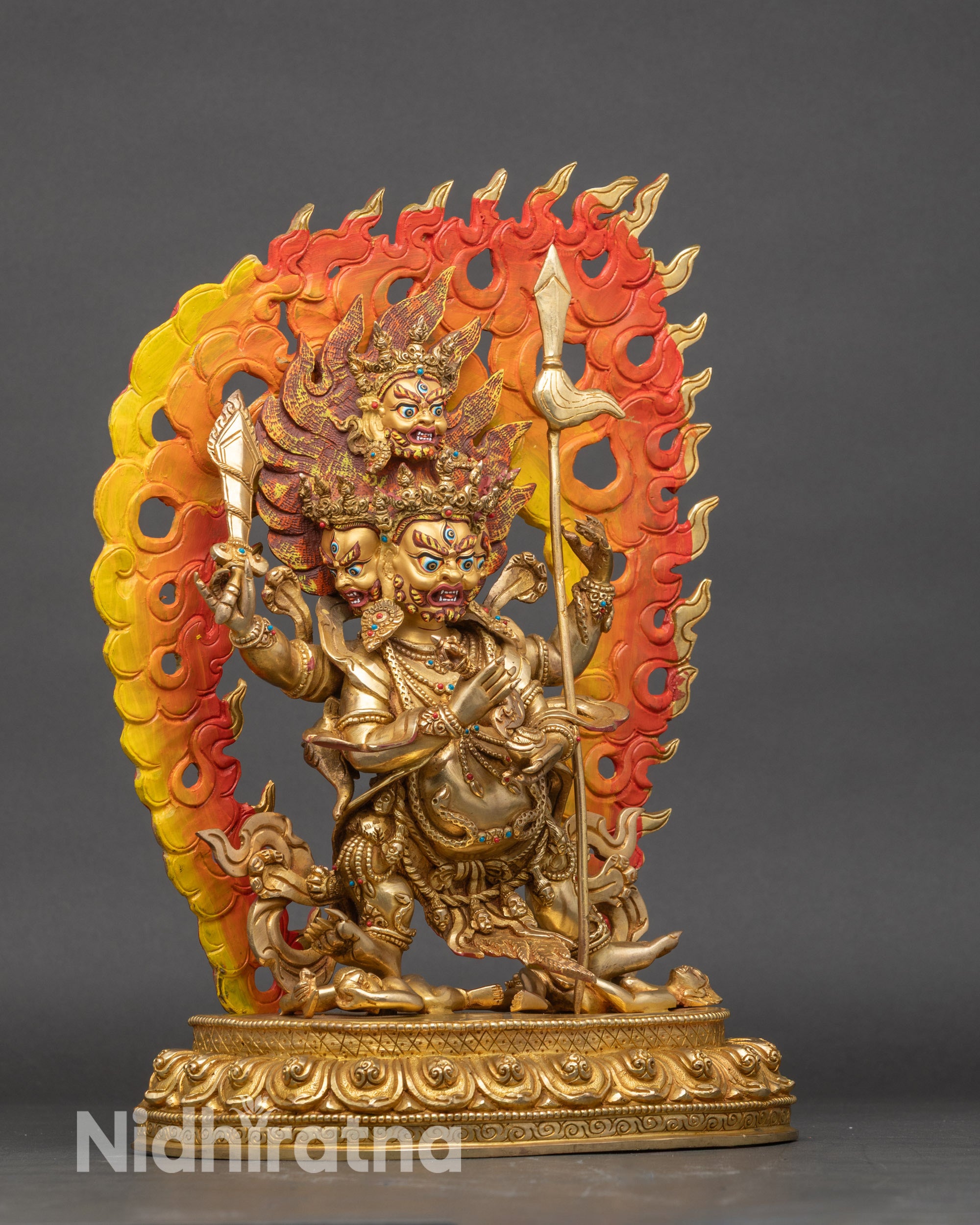 Right profile of Four-Armed Mahakala statue on lotus throne with flame halo