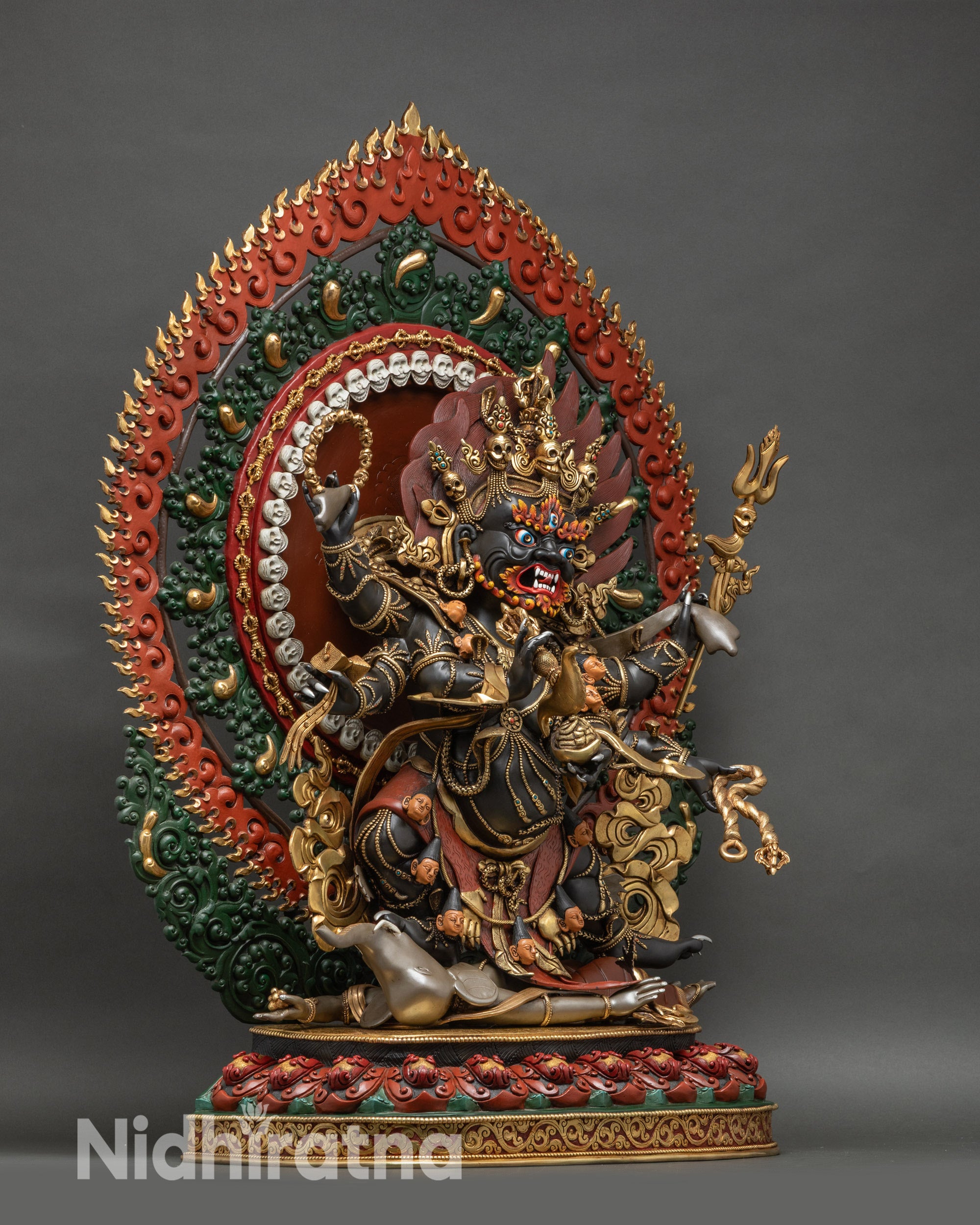 Right profile of Mahakala statue showing damaru, lasso, trident, and Kapala