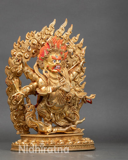 Right profile of Mahakala statue, six arms with ritual implements and lotus pedestal