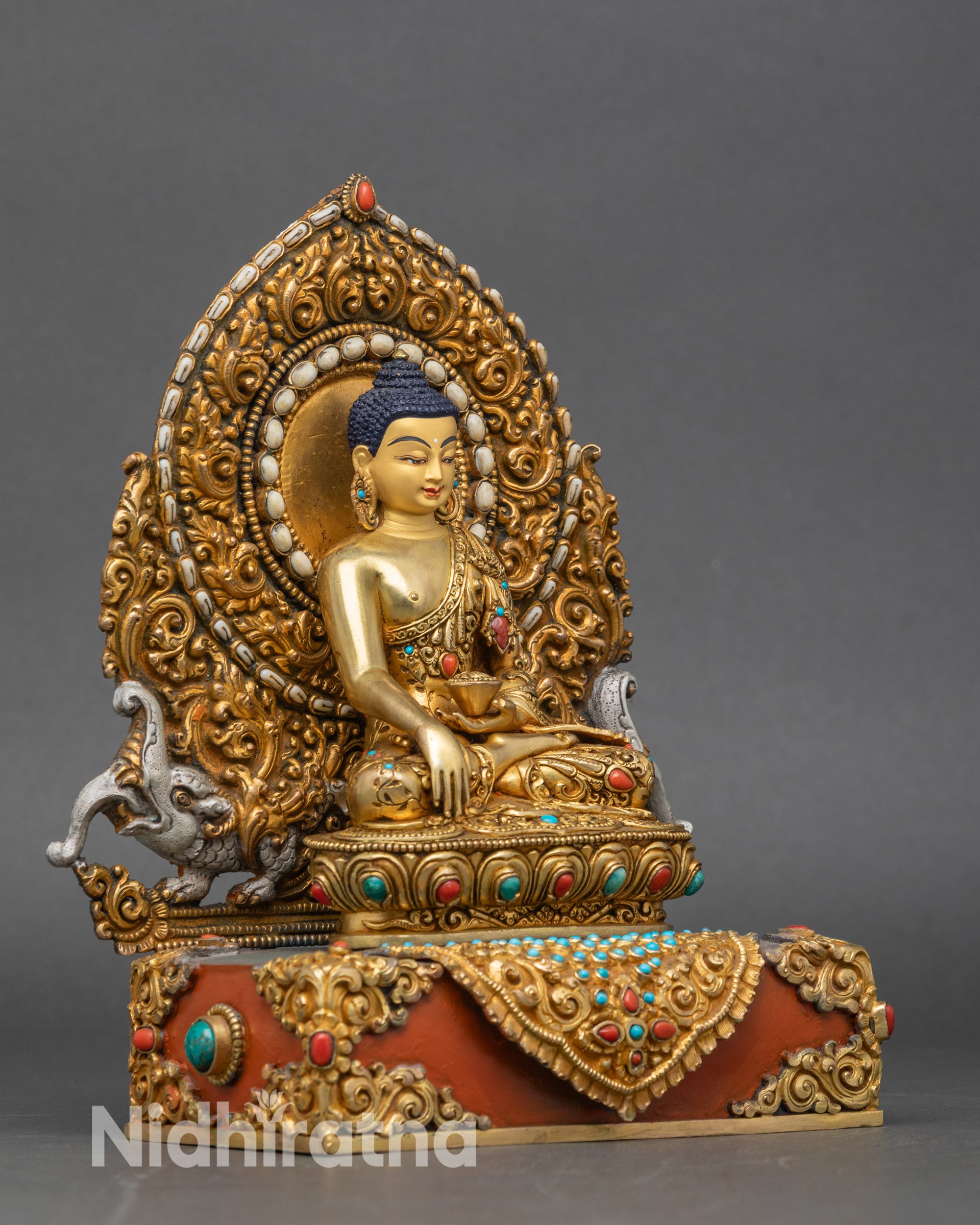 Right profile of Shakyamuni Buddha statue with semi-precious stone inlay