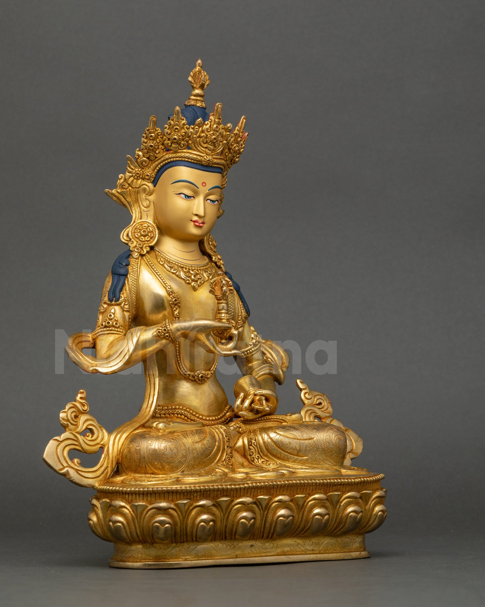 Right profile of Tibetan Dorje Sempa statue with polished gold accents