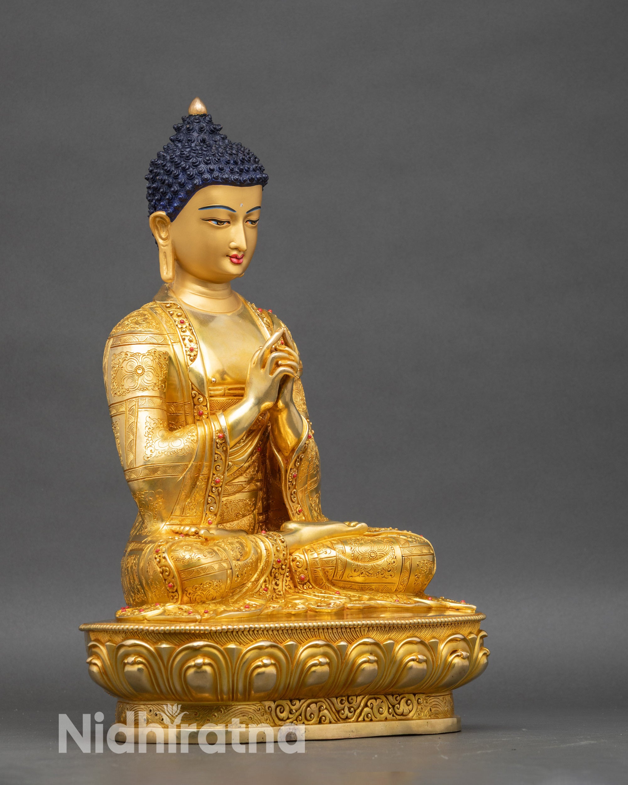 Right profile of Vairocana Buddha seated on lotus pedestal with detailed robe