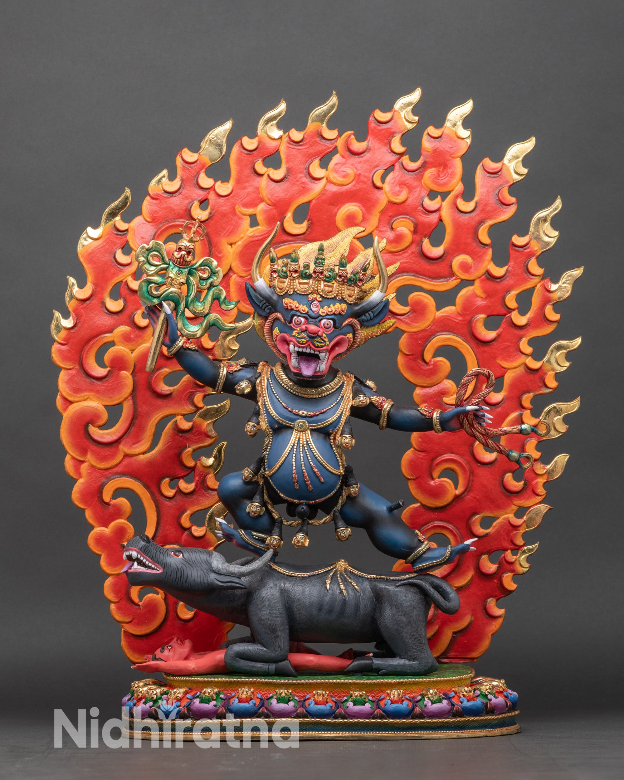 Right profile of Yamantaka statue showing yab-yum union and dynamic posture atop buffalo