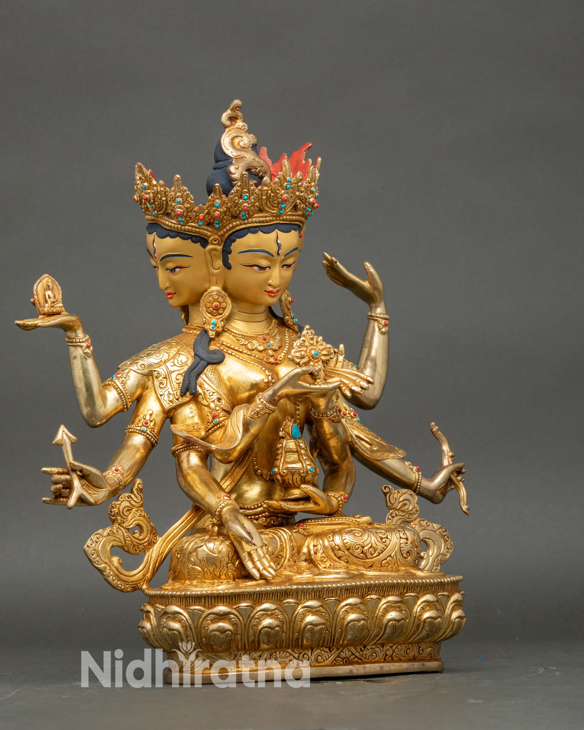 Right profile view of Dakini Namgyalma Statue, gold fire-gilded copper dakini seated on lotus flower base