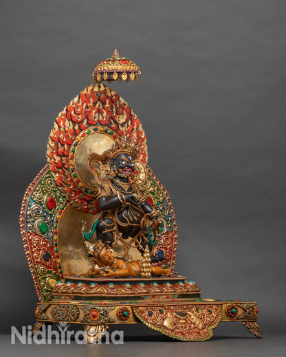 Right side of Black Dzambhala statue with kapala and decorative halo