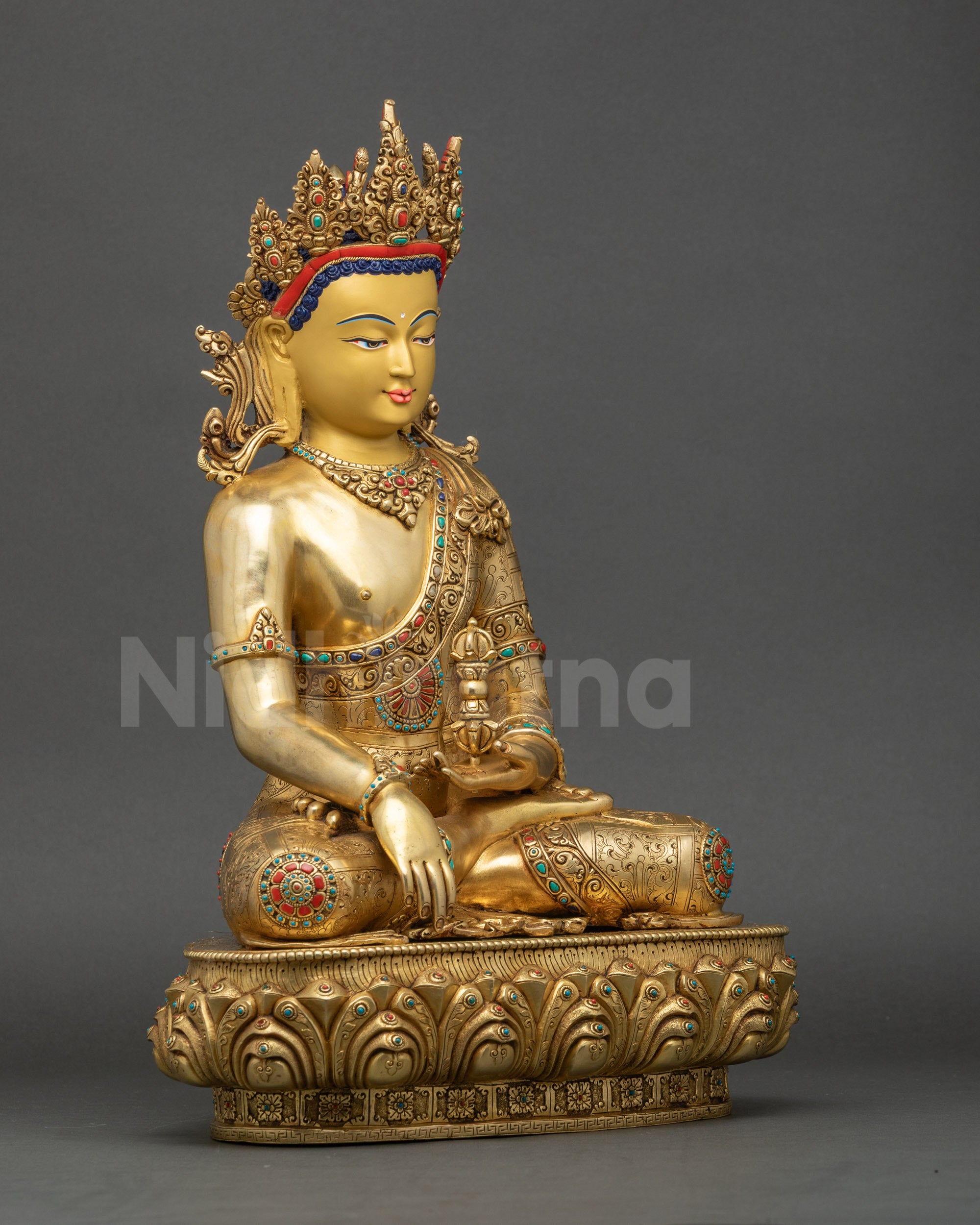 Right side of Mitrugpa Buddha statue displaying lotus seat, Vajra, and intricate robe carvings.