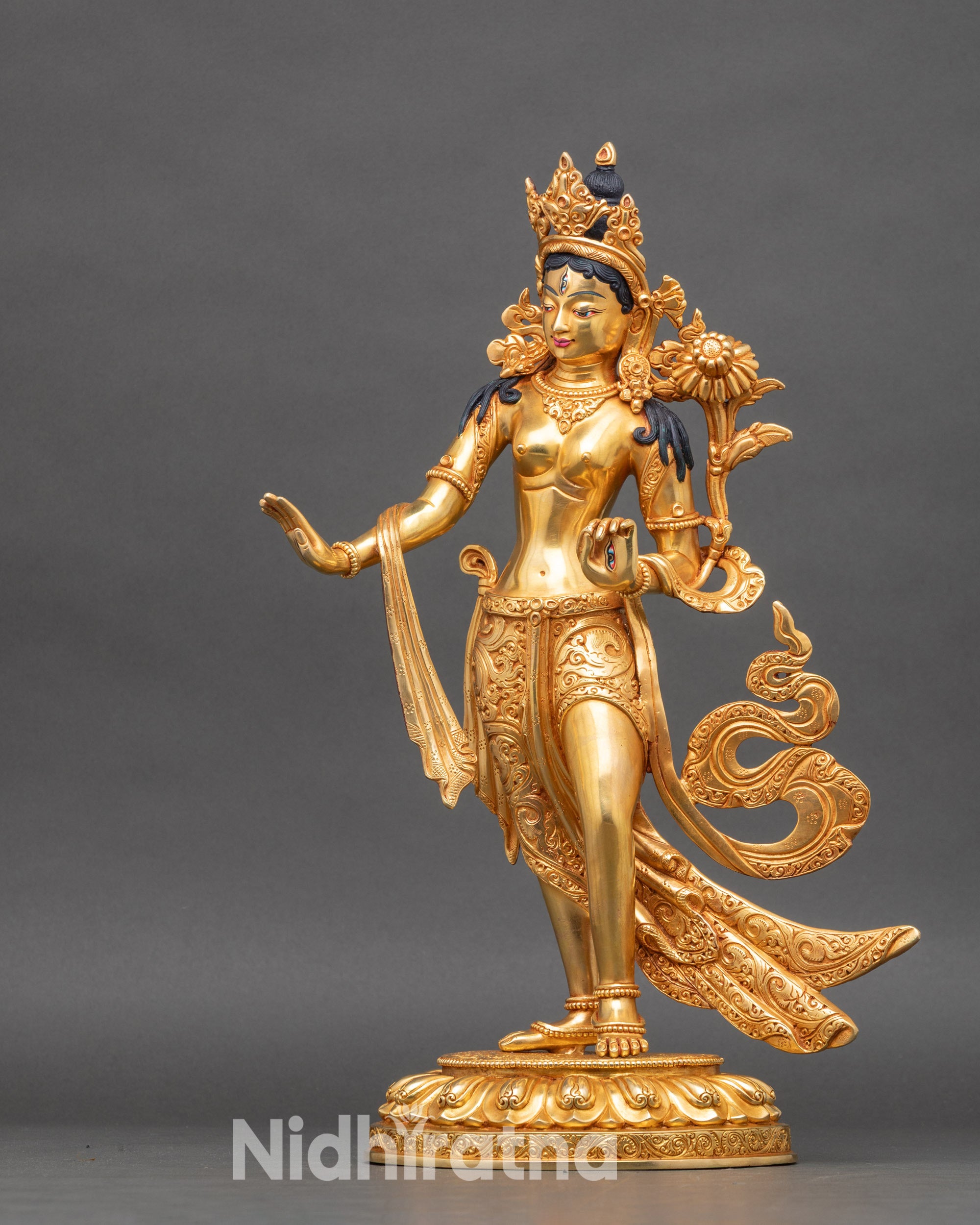 Right side of Standing White Tara statue showing Varada Mudra and lotus stem