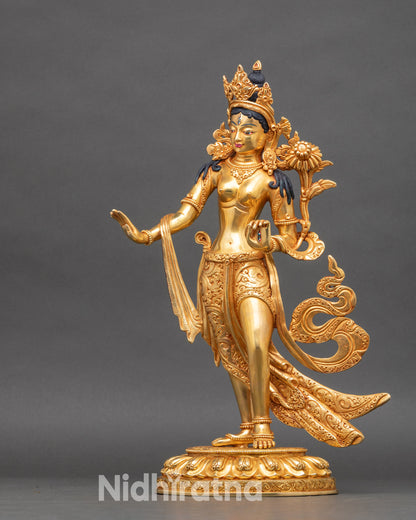 Right side of Standing White Tara statue showing Varada Mudra and lotus stem