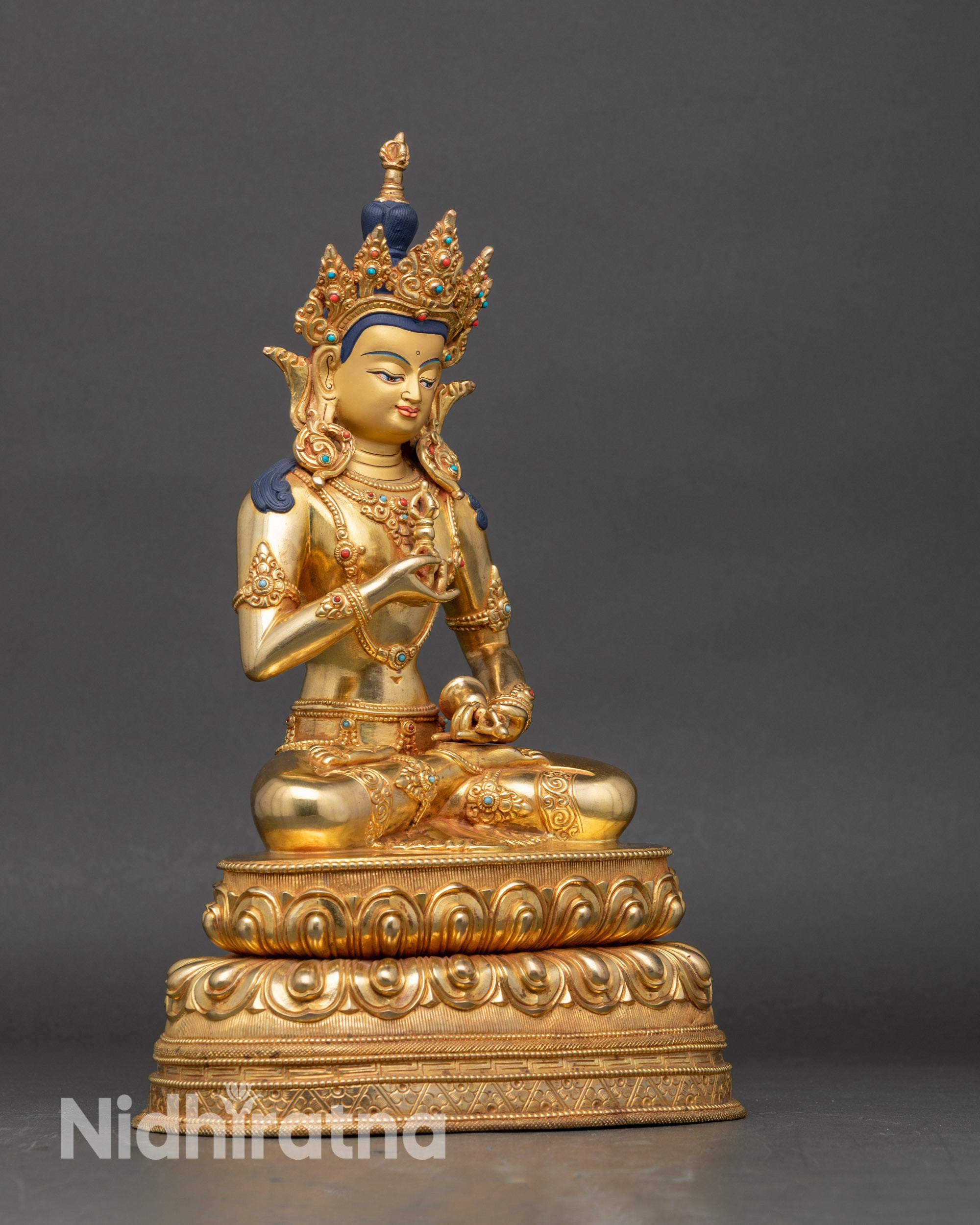 Right side of Vajrasattva statue highlighting vajra and flowing robes