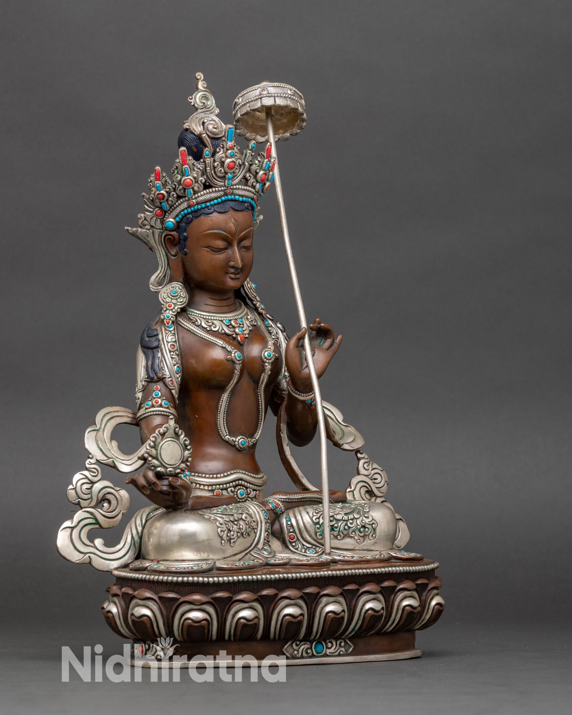 Right side view of Dukar Sitatapatra statue, showing parasol and ornate lotus pedestal