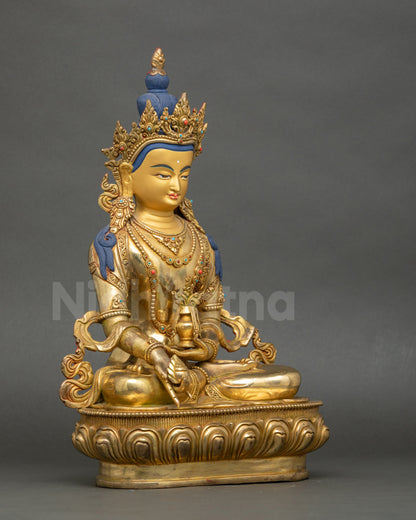 Right side view of Kshitigarbha statue seated on lotus pedestal holding jewel and vase