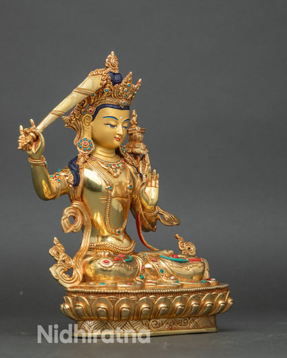 Right side view of Manjushri Bodhisattva figurine, copper sculpture with gold accents for altar