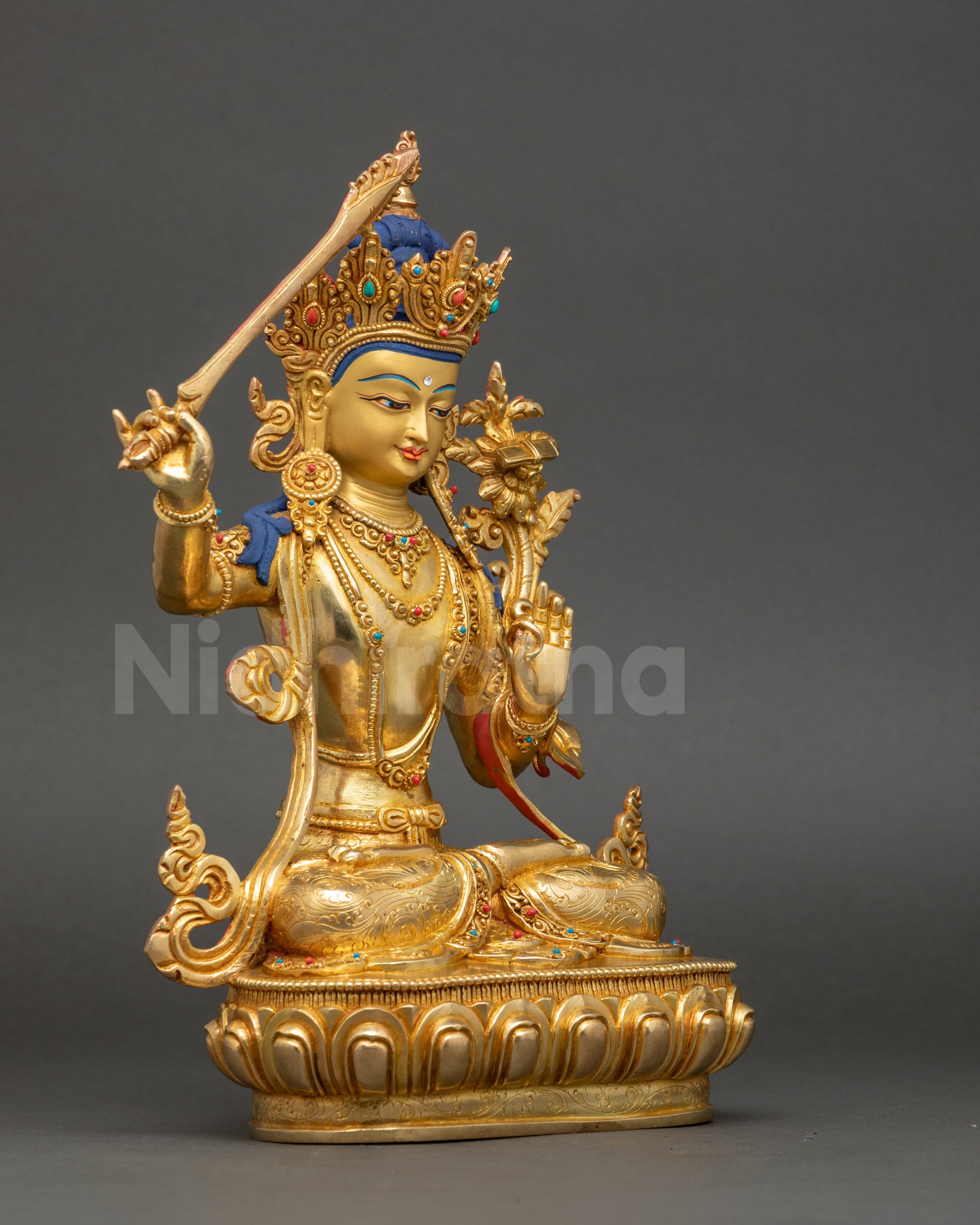 Right side view of Manjushri statue holding utpala flower and wisdom sword