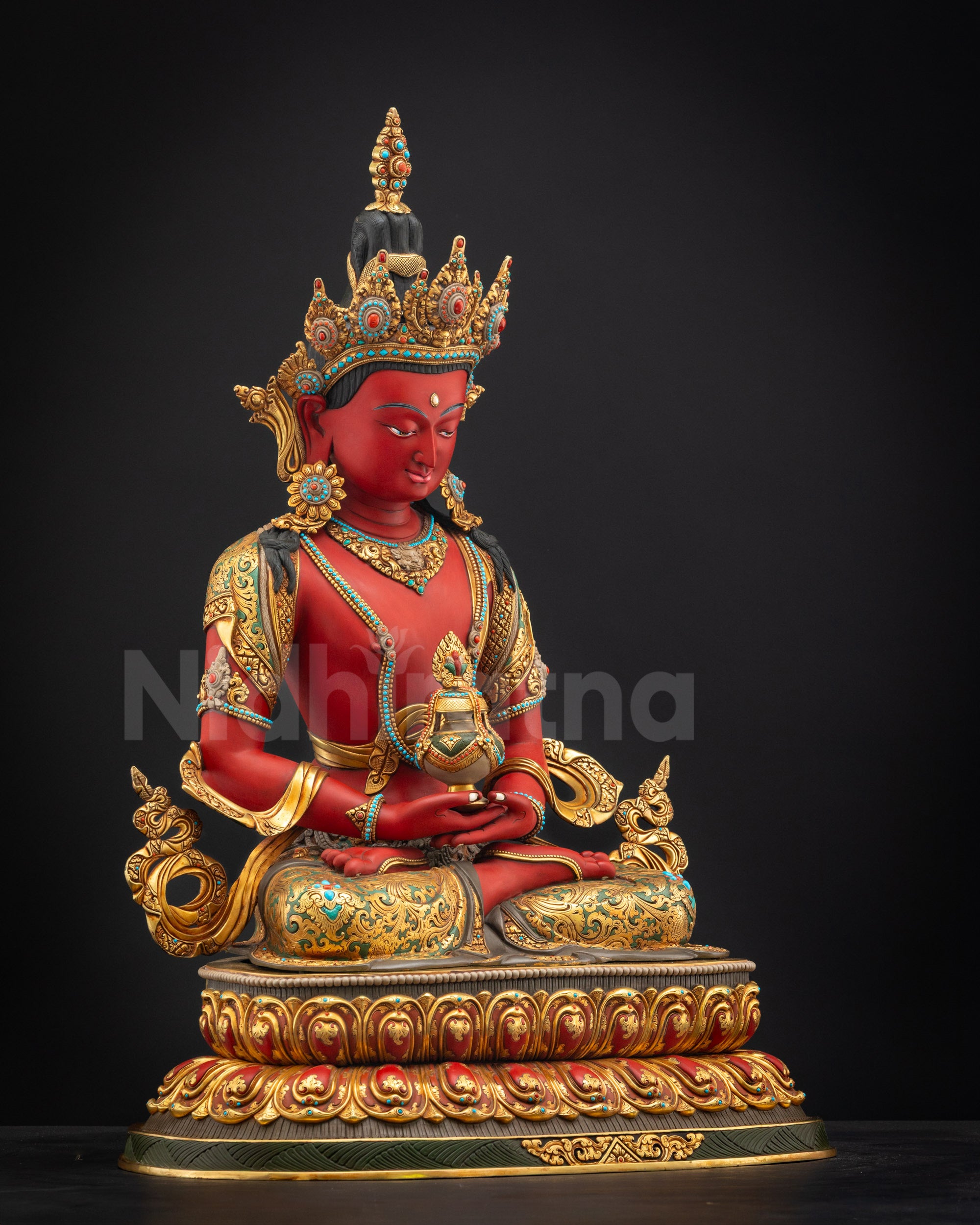 Right side view of Red Amitayus deity sculpture seated on layered lotus flower
