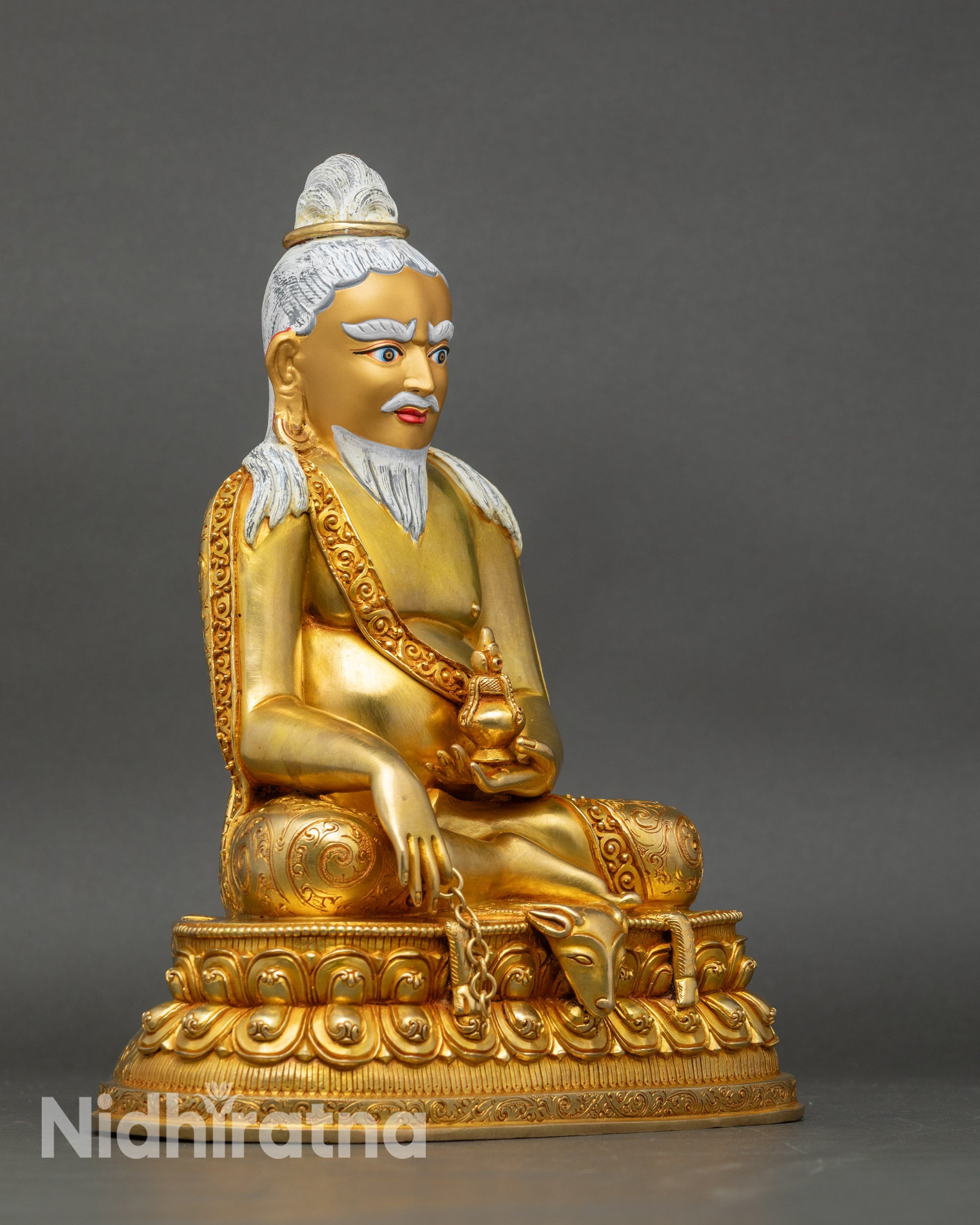 Right side view of Thangtong Gyalpo statue, seated on deer skin lotus throne