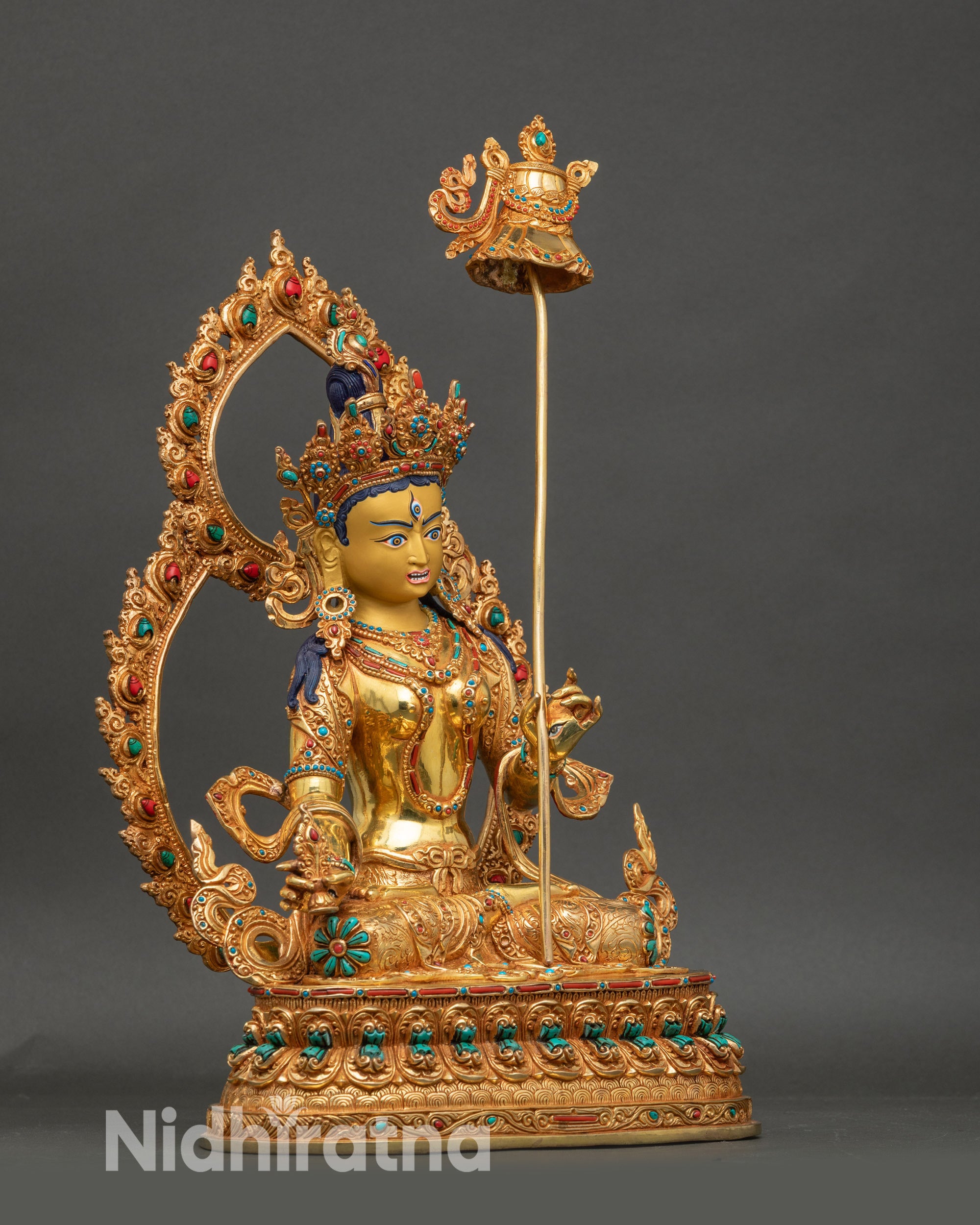 Right view of Dukar statue seated on lotus pedestal with floral halo framing