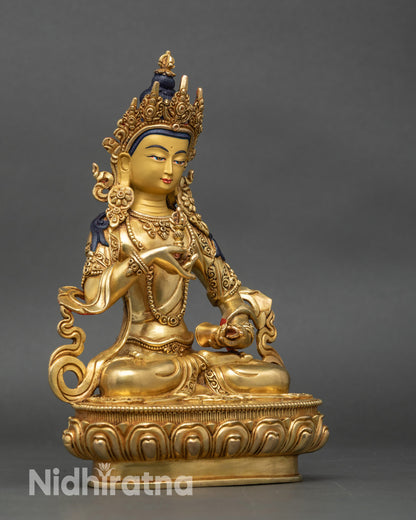 Right view of Vajrasattva statue on lotus, holding vajra and bell, gold gilded finish