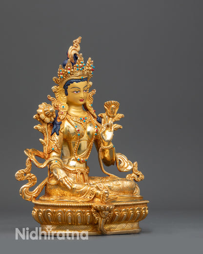 Right view side Green Tara statue seated in royal ease on lotus throne
