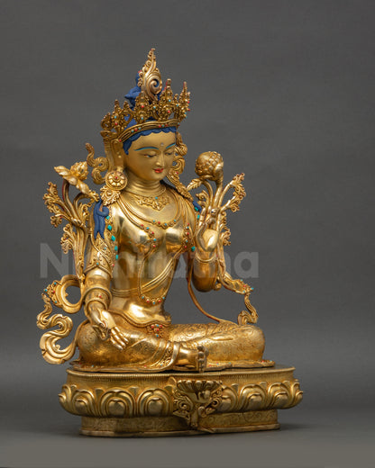 Right view side Green Tara statue showing Varada mudra and lotus throne