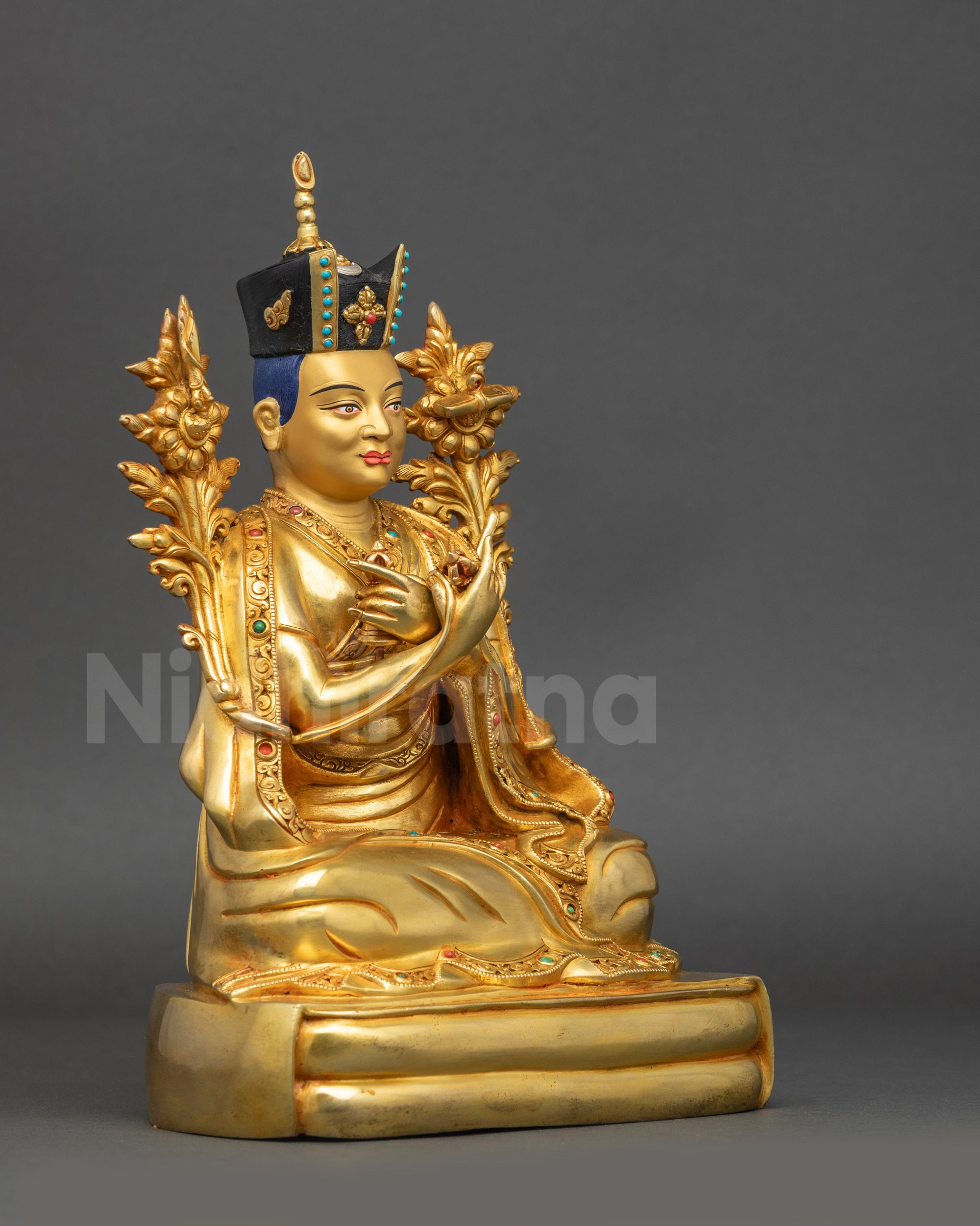 Right view side of 16th Karmapa Rangjung Rigpe Dorje statue seated on ornate pedestal
