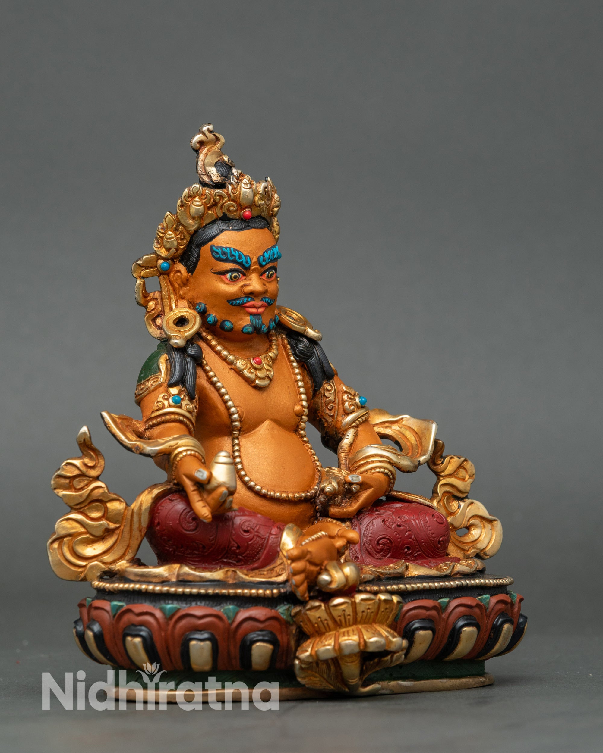 Right view side of Dzambhala Statue showing royal ease pose and lotus seat
