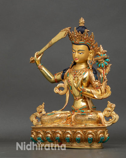 Right view side of Manjushri statue, intricate swirling robes and lotus seat
