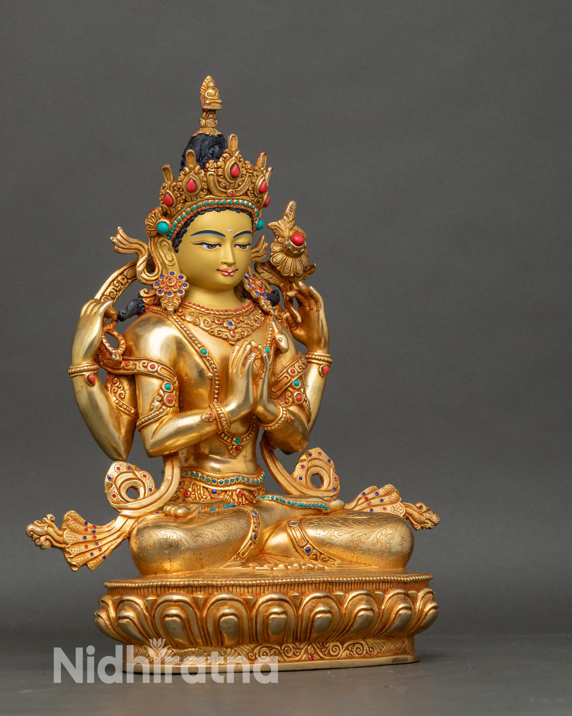 Right view side of Nepalese Avalokiteshvara statue, detailed gold-gilded robes and lotus seat