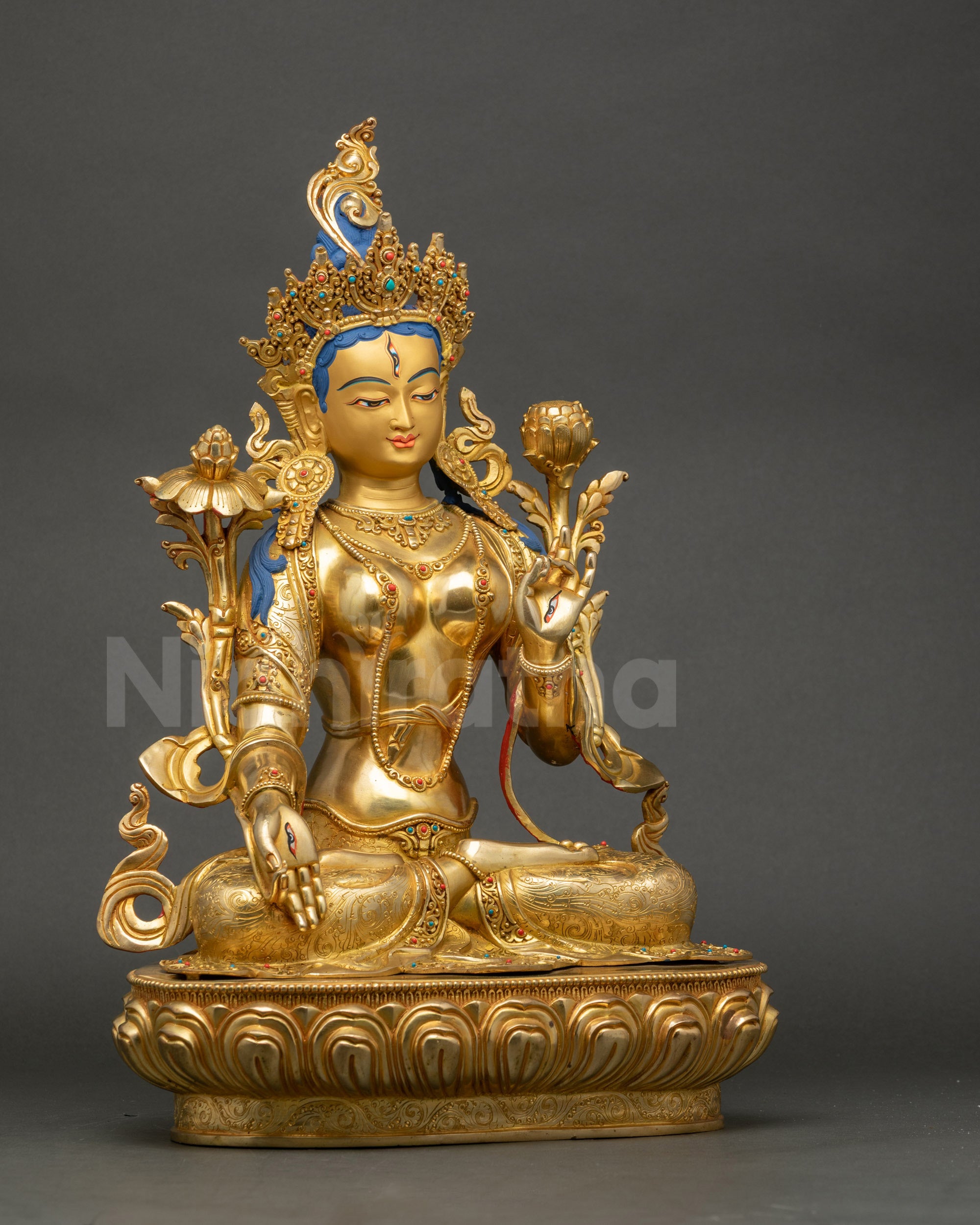 Right view side of White Tara statue seated on double lotus with carved jewelry and flowing robe