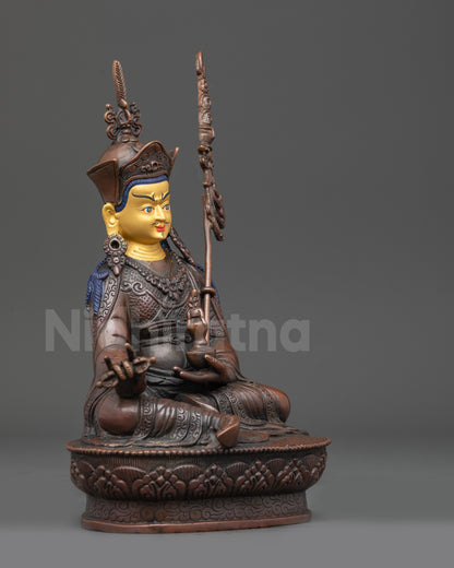 Right view side of oxidized copper Guru Rinpoche statue seated on lotus throne