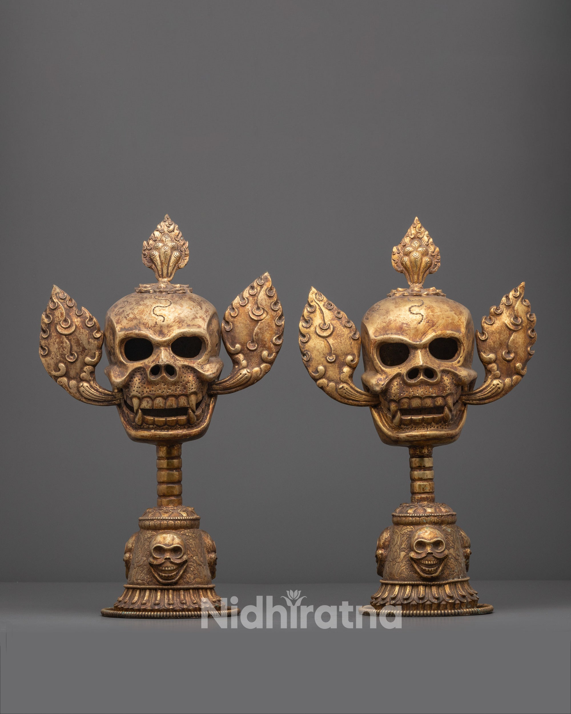 Front view of Citipati Skull Set with gold-plated crowns and copper base