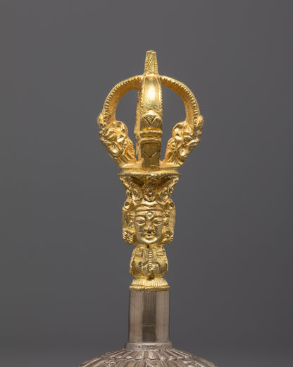 close up of vajra handle with carved patterns and sacred symbols in fine detail
