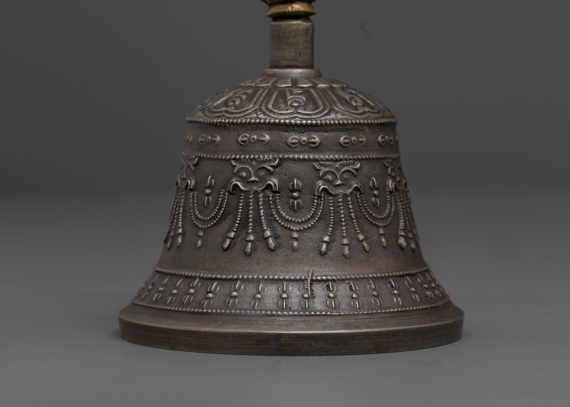 down view of bronze bell with brass deity handle for tibetan rituals